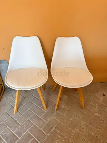 Pair of white modern dining chairs with wooden legs