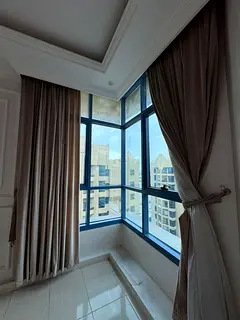 For annual rent in Ajman Creek Towers, a two bedroom apartment with living room offering a direct cr