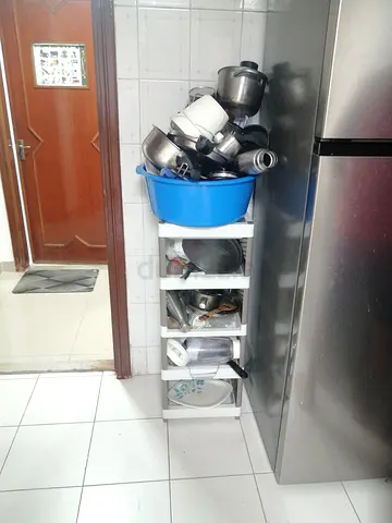 White 4-tier kitchen storage and ysed utensils and mixi black decker qith only one jar