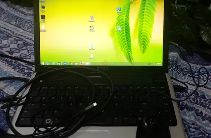 Used laptop with charger and wired mouse — working condition