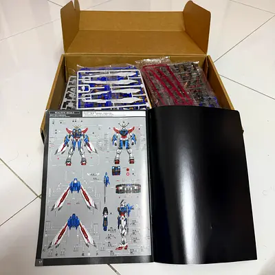 Unassembled Gundam-style model kit with manual 1/100 scale (parts on sprues)