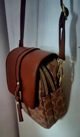 Brown patterned crossbody bag with 2 zipped pockets and adjustable strap