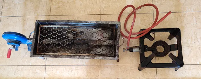 Used charcoal grill and stove with pipe.