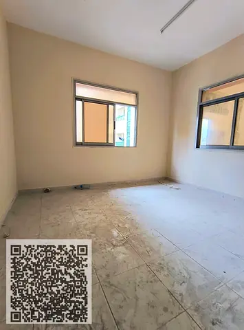 Two-bedroom apartment with a living room for annual rent in Al Rashidiya 1, Ajman, near the port road, with an open view.