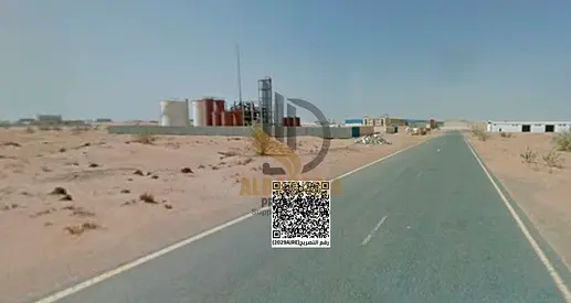 A prime industrial plot available in Umm Al Thu'ub Industrial Area, offering a strategic location directly on the main road and ready for immediate co