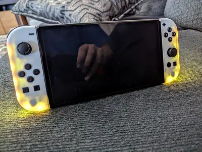 Nintendo Switch (OLED) console with light-up translucent white Joy-Con (used)