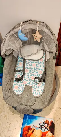 Gently used baby rocker/bouncer with canopy and hanging toys