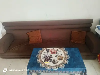 Comfortable Brown Sofa with Floral Table Cover