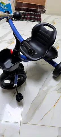 Blue toddler tricycle (used) - working pedals and storage tray
