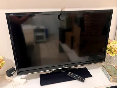 Sharp AQUOS 32-inch LCD TV - remote included, minor top damage