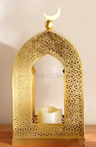 Gold Moroccan-style metal candle lantern with crescent top
