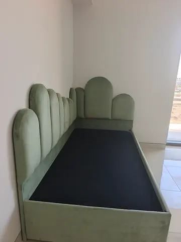 Green velvet single bed frame with scalloped headboard