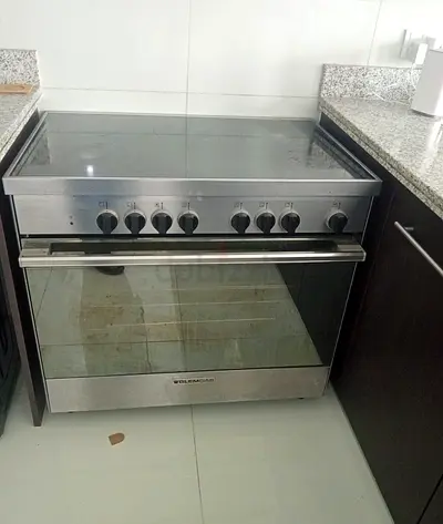 Freestanding stainless electric cooker with ceramic hob - working