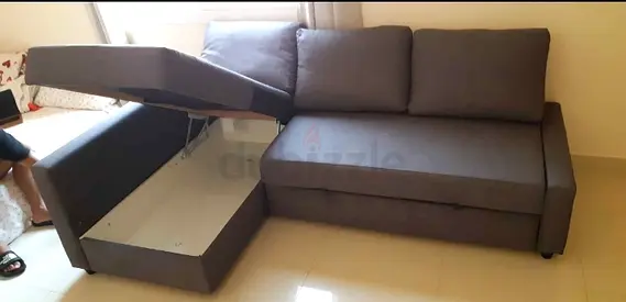 Grey L-shaped sofa bed with storage — used, good condition