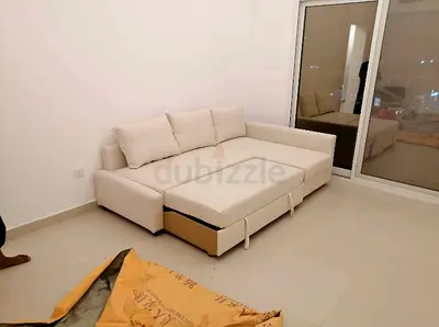 Beige L-shaped sofa bed with built-in storage - good condition