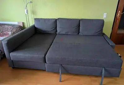 Grey L-shaped sofa bed with pull-out bed - good condition