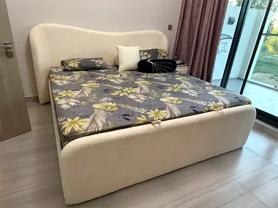 Cream bouclé upholstered bed frame — lightly used