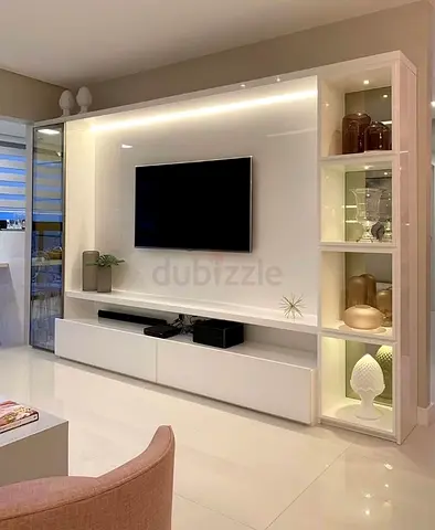 My white glossy TV entertainment center with built-in LED lighting