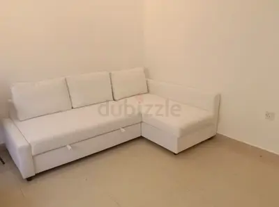 White L-shaped corner sofa bed with under-seat storage - good condition