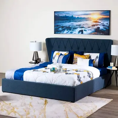 Blue upholstered king size bed with tall padded headboard