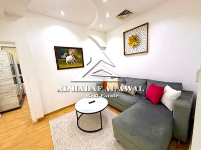 For Sale Studio apartment divided into a room and a living room, parquet flooring, with a direct view of Al Khan Lake. Fully equipped kitchen from