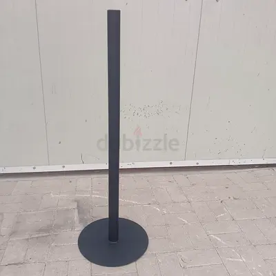 Sturdy black metal floor stand with round base