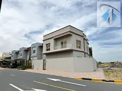 Corner villa with 5 bedrooms for annual rent in Ajman, Al Zahiyah area, on a main street with a larg