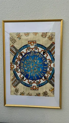 Framed Egyptian papyrus artwork with blue circular motif