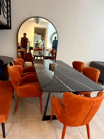 Modern black marble dining table with orange velvet chairs (6-seater)