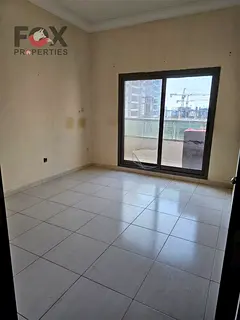 2BR in Emirates Towers, Ajman, 2 baths, balcony, free parking. Rent AED 34,000 in 4 payments, deposi