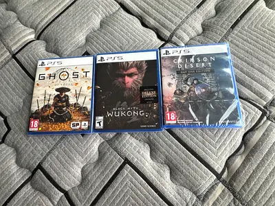 Collection of PS5 Games: Ghost of Tsushima, Black Myth Wukong, and Crimson Desert.