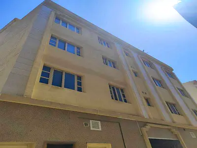 Building for sale in Muwaileh commercial area, with an area of ​​2900 square feet.