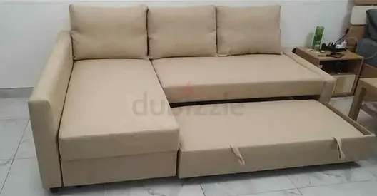 Beige L-shaped sofa with pull-out bed, good condition