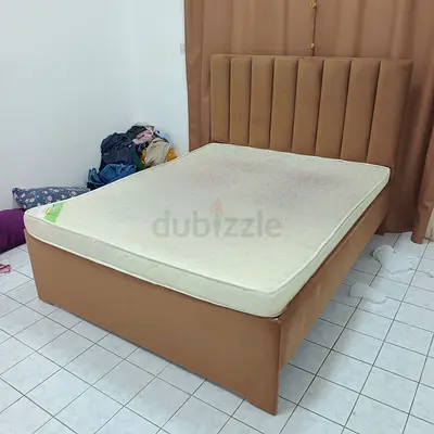 Beige upholstered bed frame with mattress (used)
