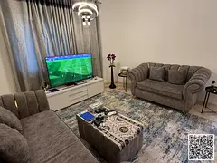 Luxury one-bedroom apartment with a living room and balcony offering an open view. Ajman Corniche, A