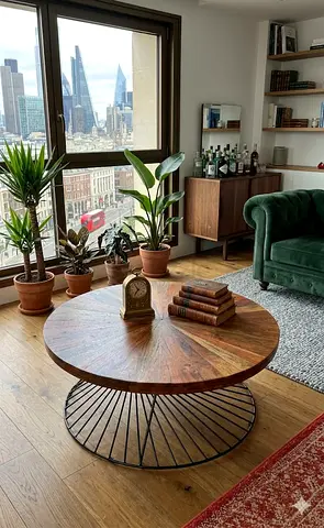 Simple  Clean Ad Modern round coffee table with solid wooden top and stylish metal base. Strong, d