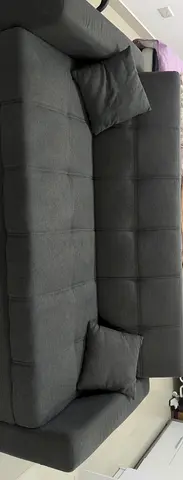 Dark grey tufted 3-seater sofa with two cushions