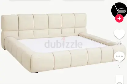 Cream upholstered low‑platform bed frame with padded headboard 180/200
