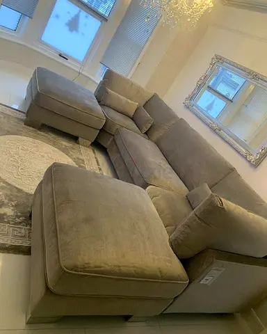 My beige L-shaped sectional sofa with ottoman