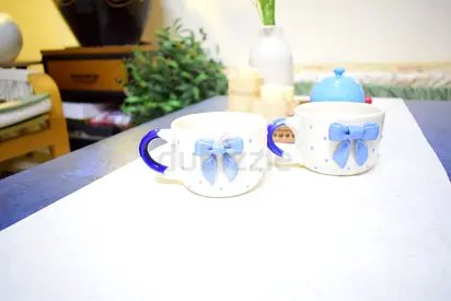 Pair of mugs with blue bow