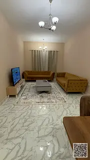 Luxury one-bedroom apartment with a living room and balcony offering an open view. Ajman, Al Rashidi