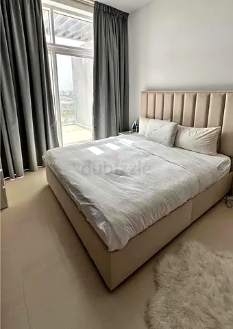 Beige upholstered platform bed with padded headboard - Good condition