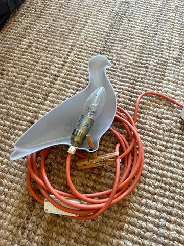 Bird-shaped lamp with bulb and long orange cord