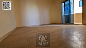 Two-bedroom apartment with a living room, annual rent, steps from Ajman Walk, with a balcony