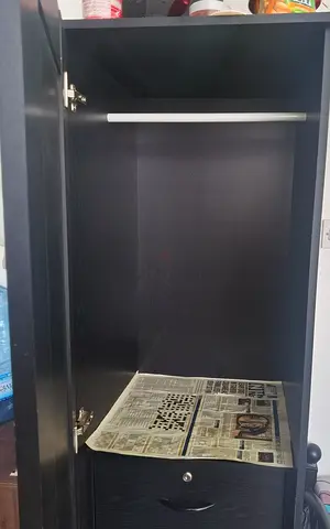 Compact brown wardrobe with hanging rail and drawer
