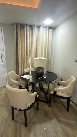 Round 4-seater dining set with cream upholstered chairs