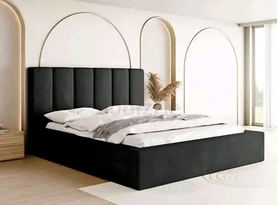 Black upholstered bed with tall channel headboard