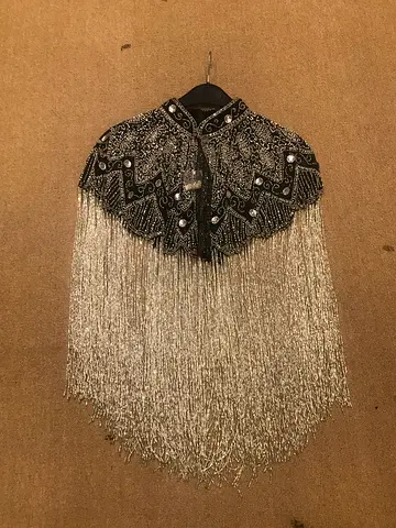 My black beaded capelet with long silver fringe