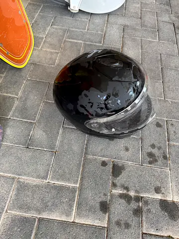 Used black full-face helmet with clear visor — some scratches