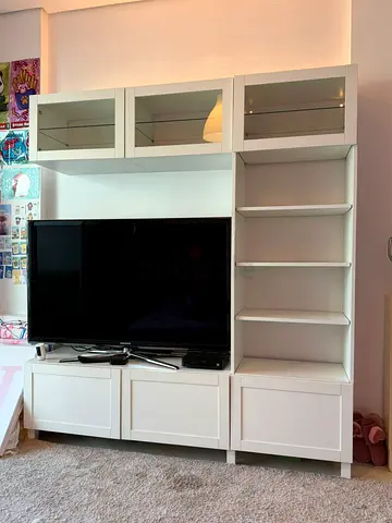 White TV entertainment unit with shelves and glass cabinets